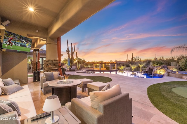 patio terrace at dusk featuring pool water feature and an outdoor living space with a fire pit