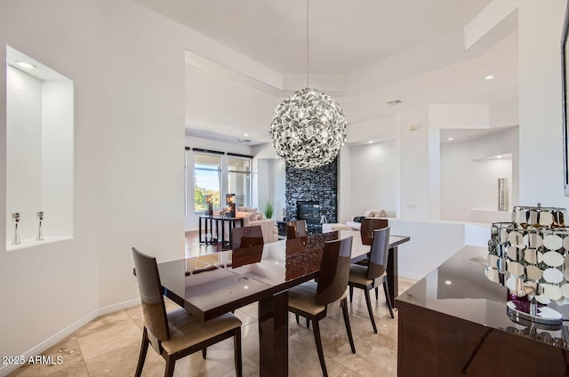 dining area with a tray ceiling and an inviting chandelier