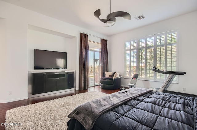 bedroom featuring hardwood / wood-style floors, ceiling fan, access to outside, and multiple windows