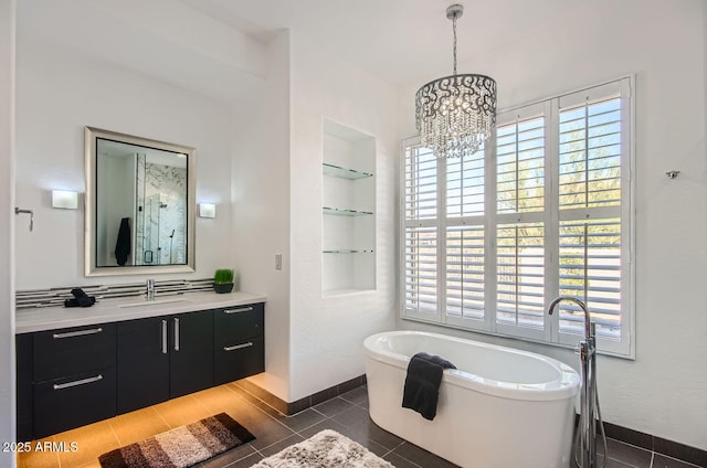 bathroom featuring vanity, a bath, built in features, a chandelier, and tile patterned flooring