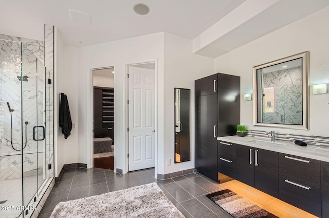 bathroom with tile patterned floors, vanity, and walk in shower