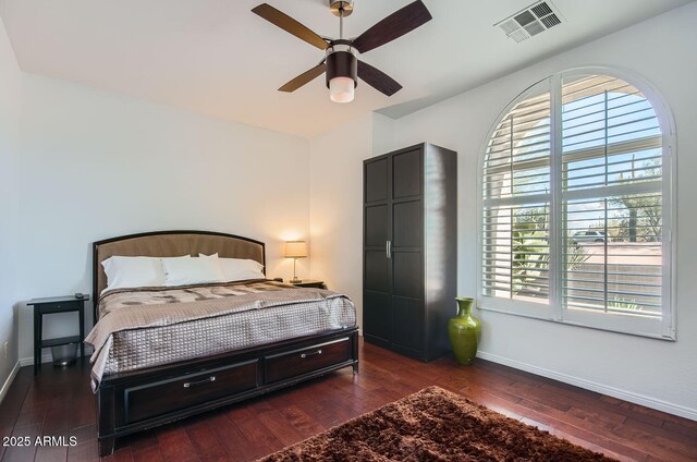 bedroom with ceiling fan and dark hardwood / wood-style flooring