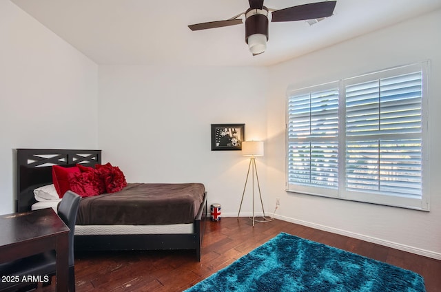 bedroom featuring multiple windows, dark hardwood / wood-style flooring, and ceiling fan