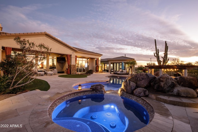 view of swimming pool with a patio area and an in ground hot tub