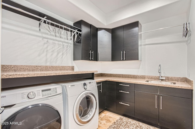 laundry room featuring cabinets, separate washer and dryer, and sink