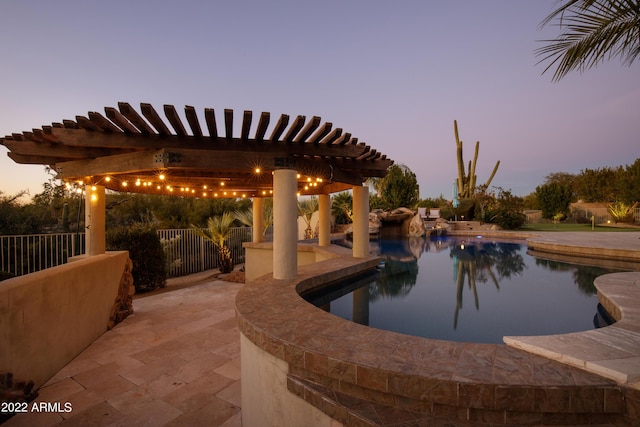 pool at dusk with a pergola and a patio