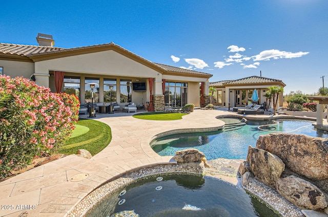 view of pool featuring an in ground hot tub and a patio