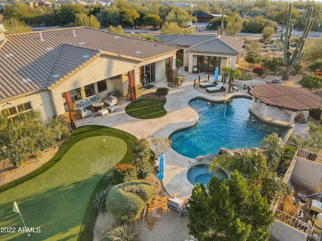 view of pool featuring a patio area and an in ground hot tub