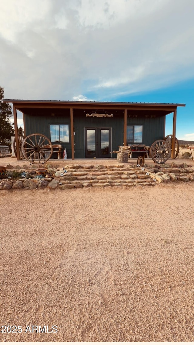 rear view of property featuring metal roof