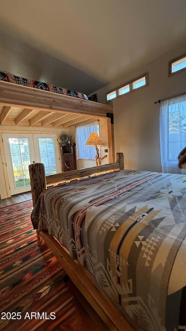 bedroom with wood finished floors and access to outside