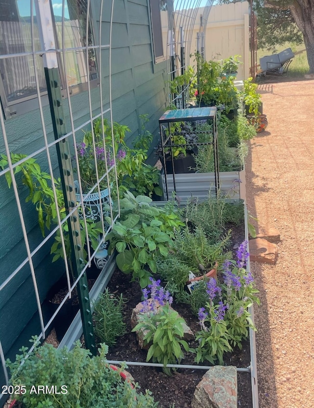 exterior space featuring a vegetable garden and fence