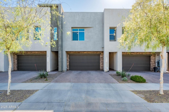 view of front of home featuring driveway, stucco siding, and an attached garage