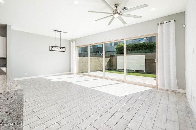 interior space with visible vents, baseboards, and a ceiling fan