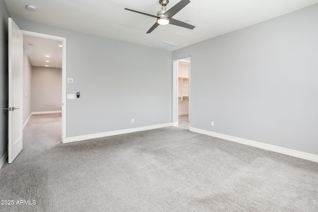 unfurnished bedroom featuring baseboards, a ceiling fan, visible vents, and carpet floors