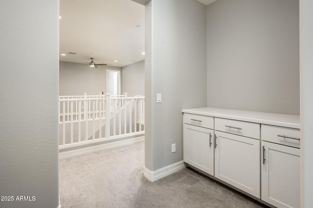 hallway featuring recessed lighting, carpet, and baseboards