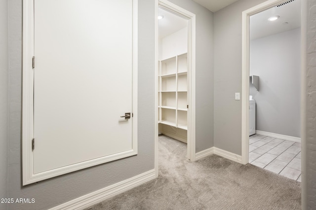 hall with baseboards and carpet floors