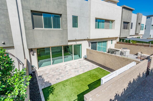 back of house featuring a patio, stucco siding, and fence