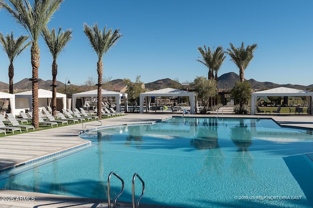 view of swimming pool featuring a gazebo and a mountain view