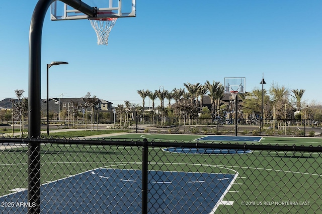 view of basketball court with fence and community basketball court