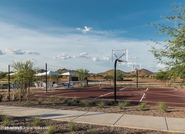 view of sport court featuring a mountain view and community basketball court