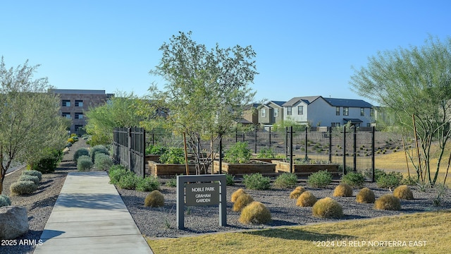 view of property's community with a vegetable garden and fence