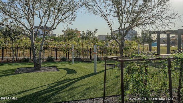 view of yard featuring fence and a vegetable garden