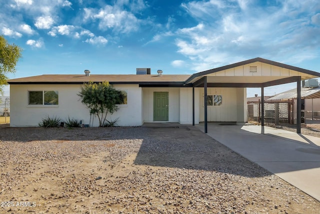 single story home featuring a carport and cooling unit