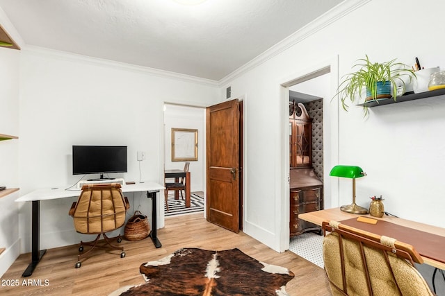 office space featuring crown molding and light hardwood / wood-style flooring