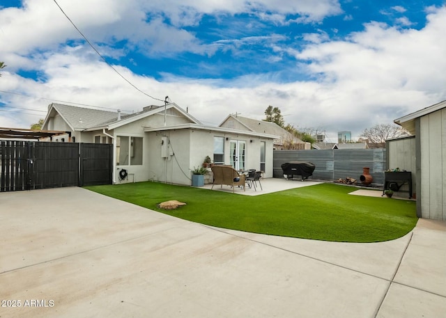 back of house featuring a yard and a patio area