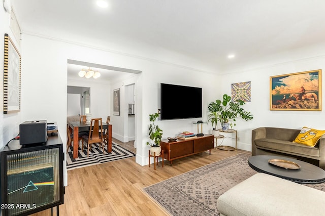 living room featuring hardwood / wood-style flooring and ornamental molding