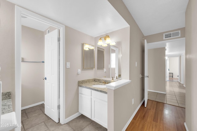 full bath with tile patterned floors, baseboards, visible vents, and vanity