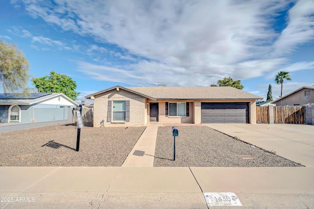 single story home featuring driveway, an attached garage, fence, and brick siding