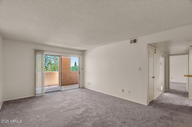unfurnished room featuring carpet flooring, a textured ceiling, and baseboards
