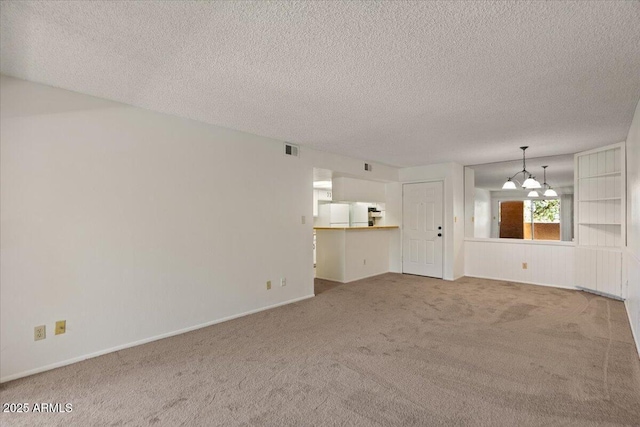 unfurnished living room featuring carpet, a textured ceiling, a chandelier, and baseboards