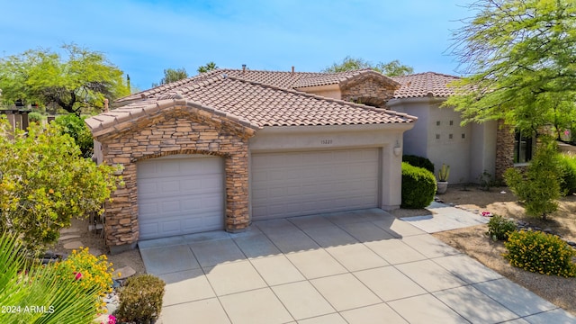 mediterranean / spanish-style home with a garage