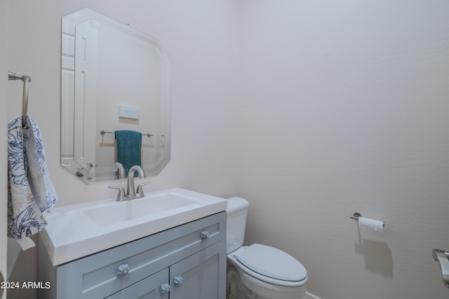 bathroom with toilet and vanity