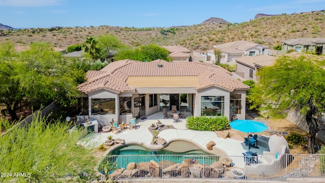 rear view of house with a patio area and a mountain view