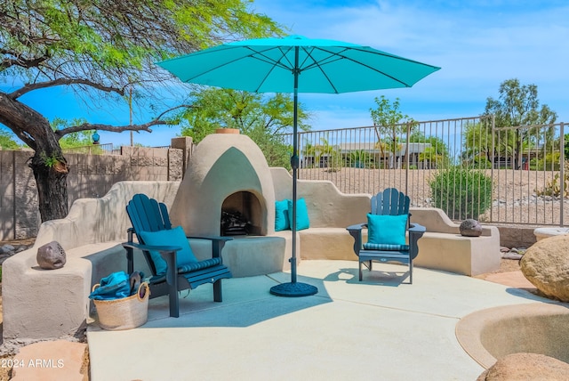 view of patio / terrace featuring an outdoor fireplace