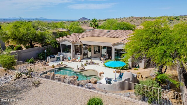 view of swimming pool with a mountain view and a patio