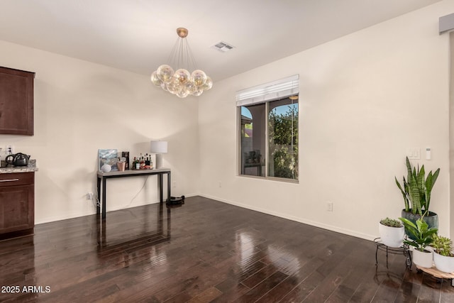 2149 E Aire Libre Ave, Phoenix, AZ 85022 - unfurnished dining area featuring dark wood-style flooring and a chandelier