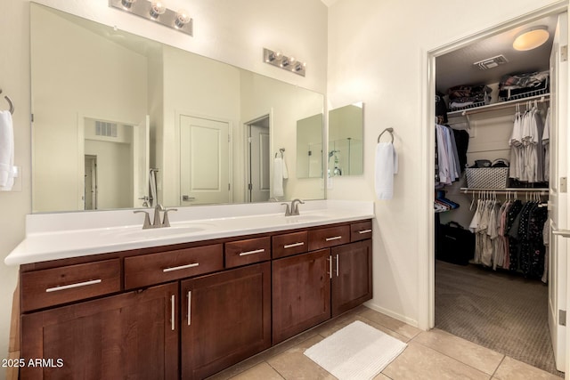 2149 E Aire Libre Ave, Phoenix, AZ 85022 - bathroom with double vanity, tile patterned flooring, and a walk in closet
