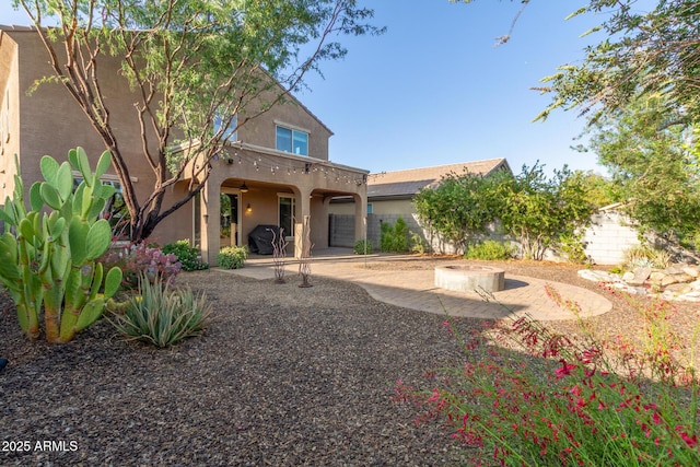 2149 E Aire Libre Ave, Phoenix, AZ 85022 - rear view of house with a fire pit, a ceiling fan, a patio, and stucco siding
