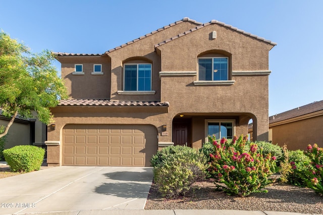 2149 E Aire Libre Ave, Phoenix, AZ 85022 - mediterranean / spanish-style home featuring stucco siding, a tile roof, a garage, and concrete driveway