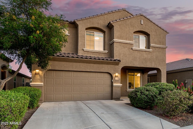 2149 E Aire Libre Ave, Phoenix, AZ 85022 - mediterranean / spanish house featuring stucco siding, a tiled roof, concrete driveway, and a garage