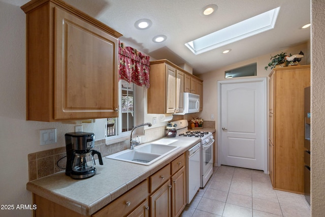 2080 W Pine Grove Dr, Show Low, AZ 85901 - kitchen featuring a skylight, white appliances, lofted ceiling, light tile patterned floors, and light countertops