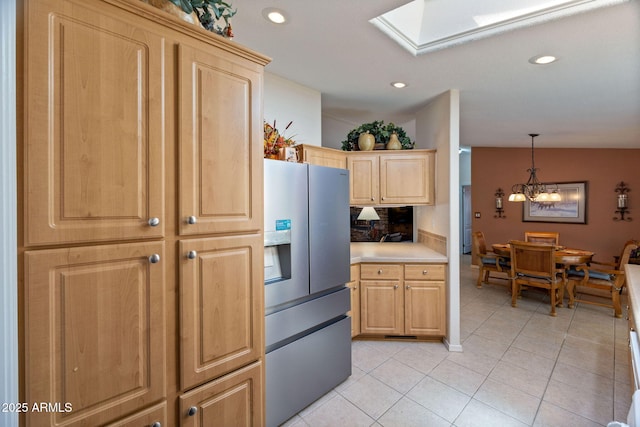 2080 W Pine Grove Dr, Show Low, AZ 85901 - kitchen featuring stainless steel fridge, a skylight, light tile patterned floors, light countertops, and a chandelier