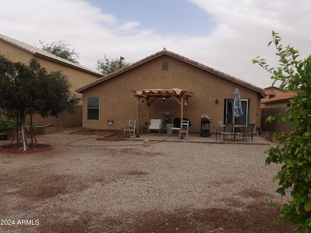 rear view of property featuring a patio area