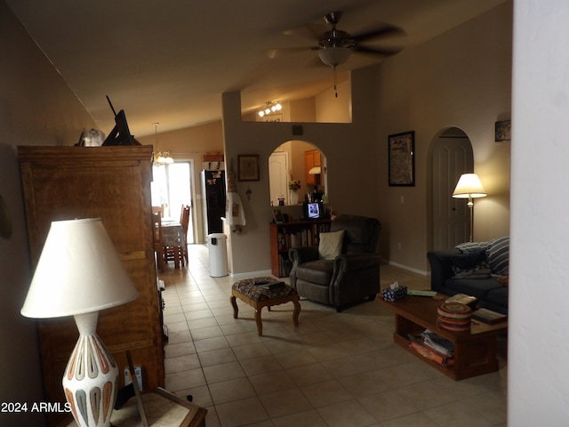 tiled living room with ceiling fan and vaulted ceiling