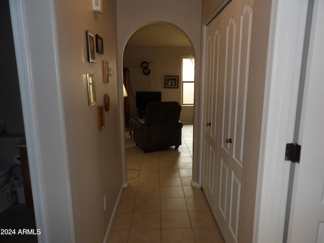 corridor featuring light tile patterned floors