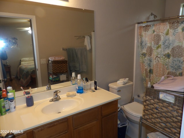 bathroom with vanity, curtained shower, and toilet